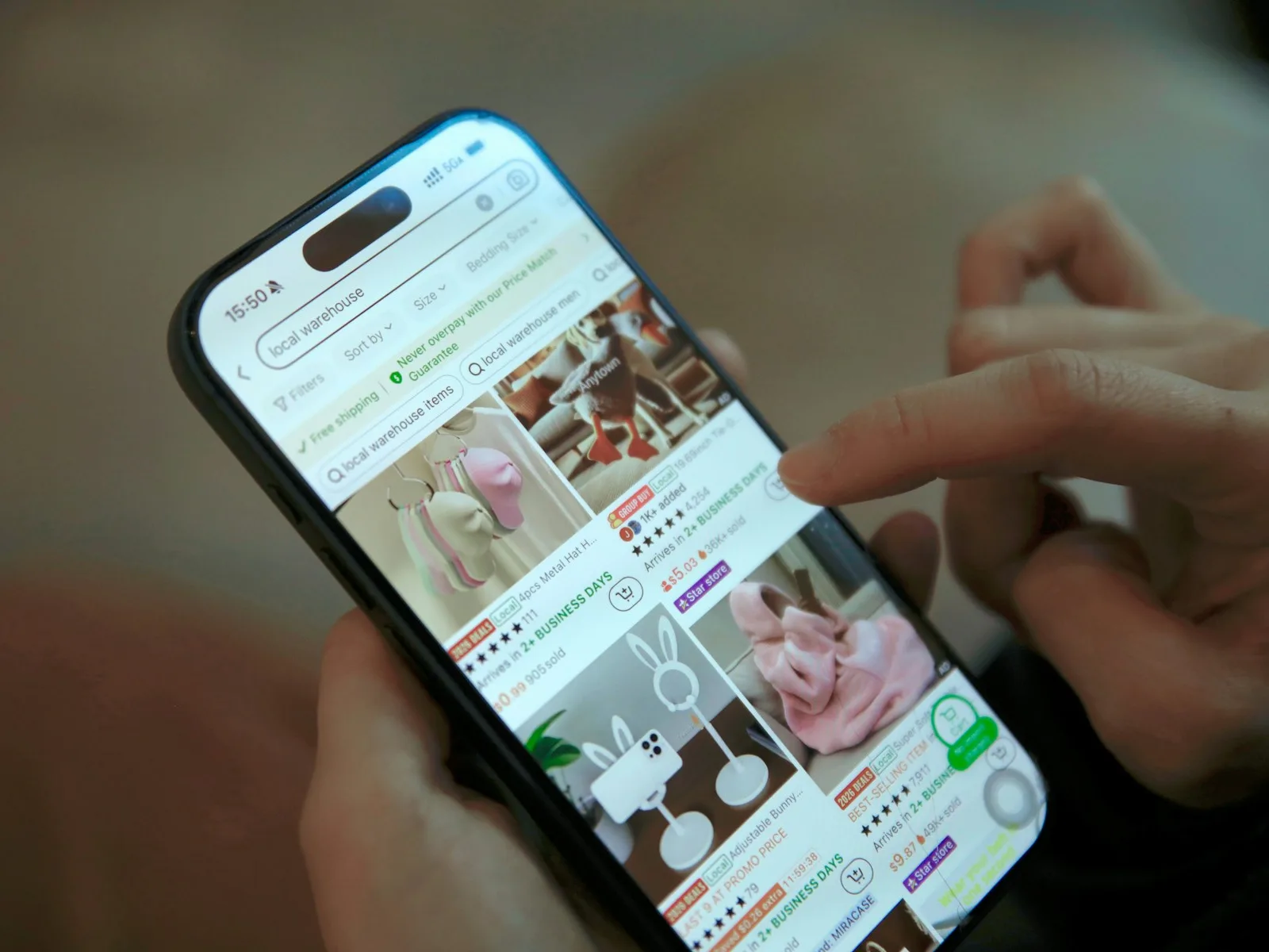 Hand wählt ein Produkt in einer mobilen Einkaufsoberfläche auf dem Smartphone aus.